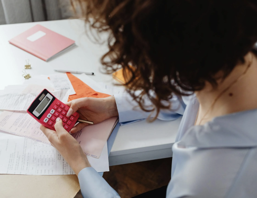 Woman Holding a Pink Calculator